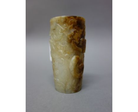 A small Chinese jade cylindrical vase, 18th/19th century, the stone of greyish tone with russet inclusions, carved with chilo