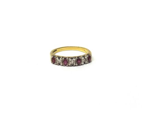 An 18ct gold, ruby and diamond set seven stone half hoop ring, mounted with alternating circular cut rubies and diamonds, rin