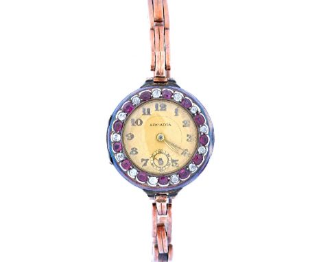 An Arcadia lady's 9ct gold, ruby and diamond set circular cased dress wristwatch, with an unsigned jewelled movement, the sig