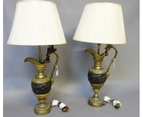 A near pair of Victorian style gilt and patinated brass table lamps, early 20th century, each 'ewer' body with figural finial