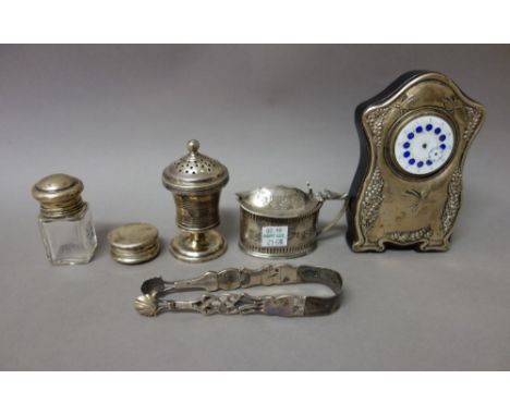 Silver and silver mounted wares, comprising; a small clock, Birmingham 1909, a glass smelling salts bottle, an oval mustard p