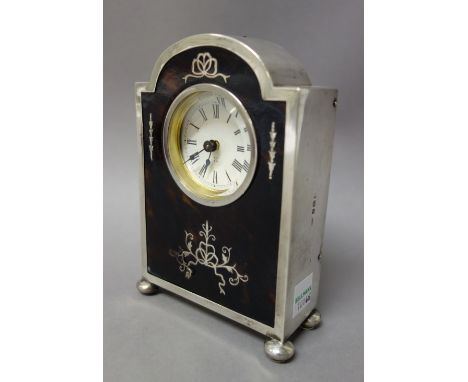 A silver and tortoiseshell mounted rear winding mantel clock, the circular dial with Roman numerals and with blued steel hand