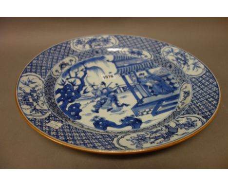 A Chinese blue and white dish, Kangxi, painted with a figure on a terrace waving goodbye to a young man and woman, beneath a 