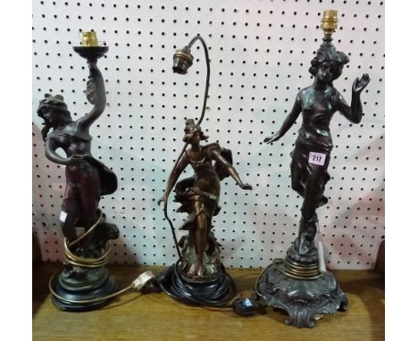 A 20th century spelter figural table lamp modelled as a woman and two similar faux metal resin examples, (3).  F9