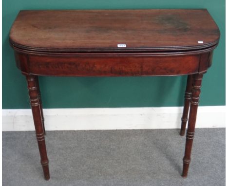 A Regency mahogany card table, the 'D' shaped top on turned supports, 91cm wide x 45cm deep x 75cm high.  I6