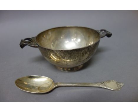 An Irish silver twin handled christening porringer of circular form, the gem set handles with Celtic inspired decoration, rai