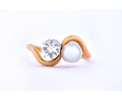 A gold, diamond and cultured pearl set ring, claw set with a cushion shaped diamond and with a cultured pearl, in a crossover