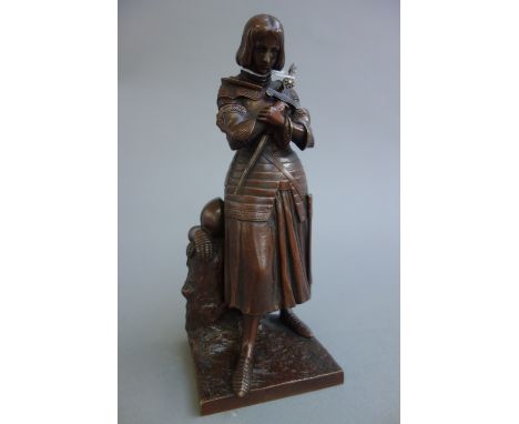 A French patinated bronze depicting Joan of Arc, late 19th century, stamped with Susse Freres foundry mark, on a naturalistic