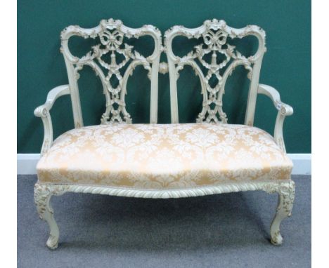 A Chippendale Revival gold and cream painted double chair back sofa, on scroll supports, 120cm wide x 98cm high.