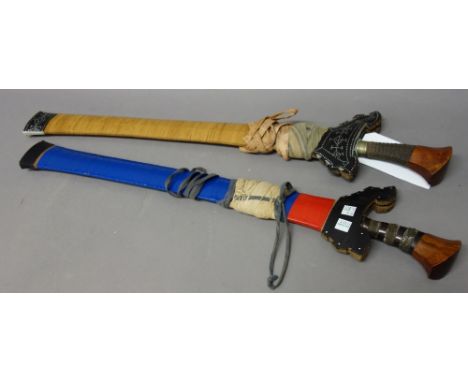 Two Southern Philippines kris, the first with shaped steel blade (58cm long) and cord bound wooden handle, in an inlaid woode
