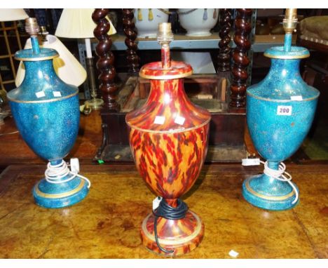 A pair of blue and gilt tole painted urn shaped table lamps and a similar lamp with faux tortoiseshell decoration, (3).  G4