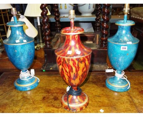 A pair of blue and gilt tole painted urn shaped table lamps and a similar lamp with faux tortoiseshell decoration, (3).  G4