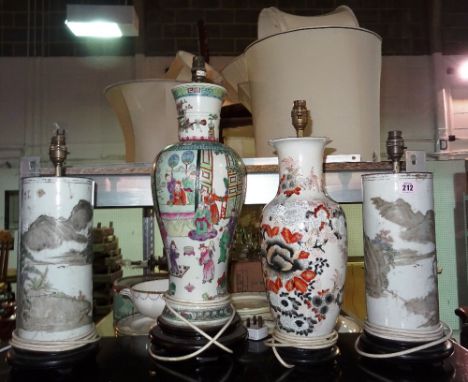 A pair of Asian cylindrical table lamps, decorated with landscape and script and two further Asian lamp bases, (4).  F4