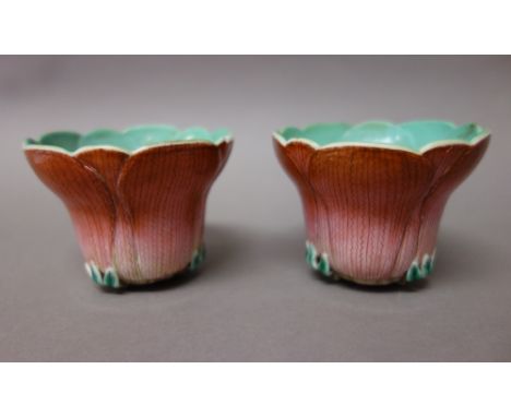 A pair of Chinese porcelain cups, 20th century, each in the form of a lotus flower, turquoise interiors, 6cm. high