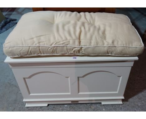 A 20th century white painted lift top trunk with a small quantity of 20th century toys, 92cm wide x 56cm high.  K5