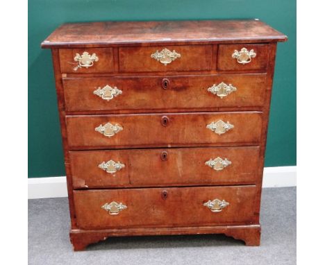 A mid-18th century figured walnut chest of three short and four long graduated drawers, on bracket feet, 107cm wide x 114cm h