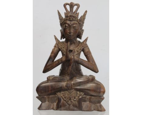Eastern carved hardwood figure of a Buddha seated on a triangular lotus throne, 28cm high, signed with carved initials R. S. 