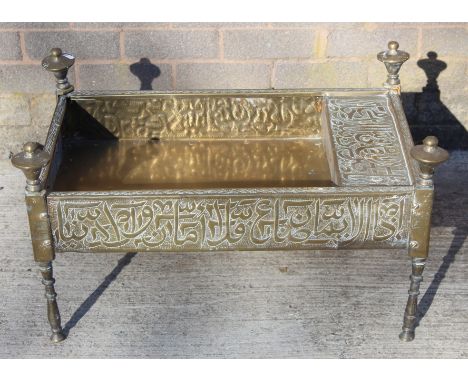 Islamic Cairoware brass trough of rectangular twin handled form with two fixed handles and four turned finialled legs, with i