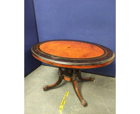 Victorian ebonised burr walnut and amboyna loo table, the oval top decorated with allover carved scrolls, raised on quadrapar