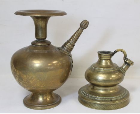 Two Eastern brass hookah bases, one of baluster form with flared rim, twisted conical spout with bud finial and applied bird 