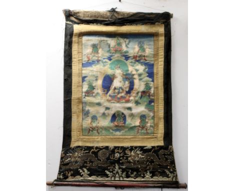 Antique Tibetan Buddhist Thangka depicting Guanyin seated on a lotus throne surrounded by eight smaller deities or bodhisattv