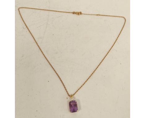 Gold pendant with rectangular amethyst and diamond, probably '14'. 