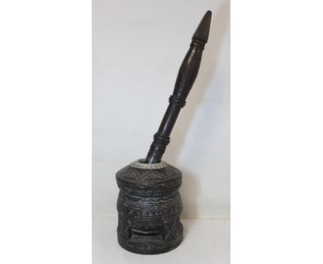 North African Bedouin coffee grinder in stained hardwood with carved decoration and white metal mount to rim, the mortar 24cm