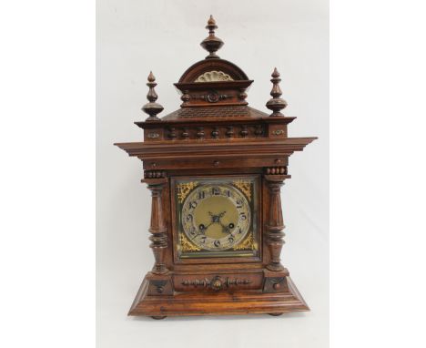 Junghams mantel clock with silvered and ivory dial, in walnut and rosewood case with turned columns. 59cm. 