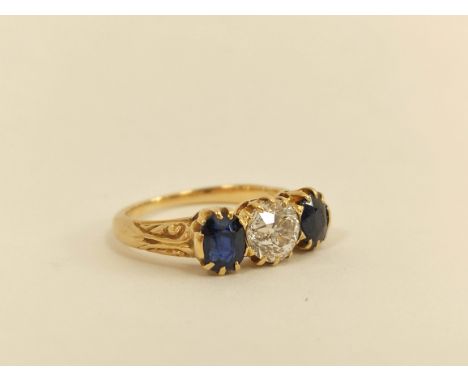 Edwardian gold ring with diamond brilliant approx. .75ct and two sapphires in engraved gold, probably 18ct.  Size L    Condit