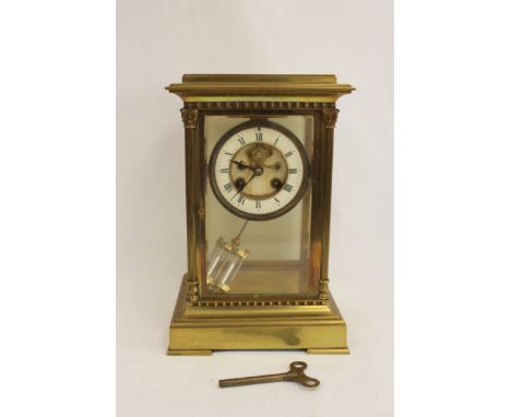 French mantel clock of 'four glass' style with visible escapement, 'mercury' pendulum and fluted column corners. 29cm. 