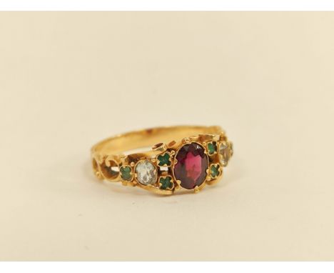 Victorian engraved gold ring with oval garnet, chrysolite and tiny emeralds. Old repairs.&nbsp;Good apart from soft soldiered