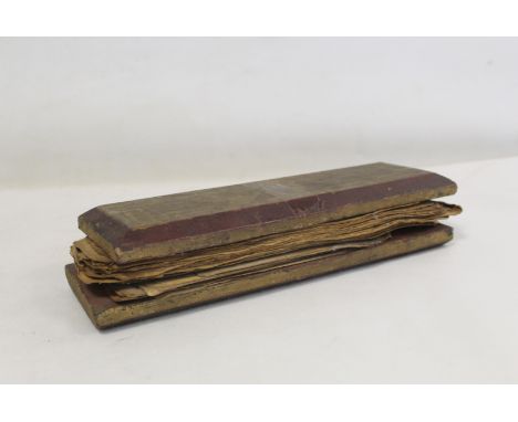 19th century Indo-Tibetan prayer book with various manuscript leaves held between two wooden boards, 7cm long. 