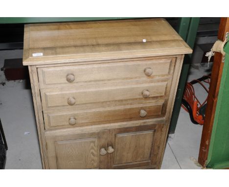 Light wood chest of three drawers above two cupboard doors