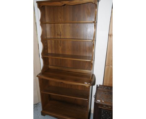 Ercol elm bookcase with three tiered upper raised top above open base