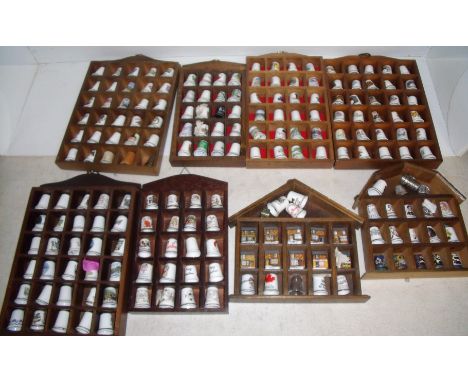 Large selection of thimbles including glass, pewter and ceramic and wooden display stands