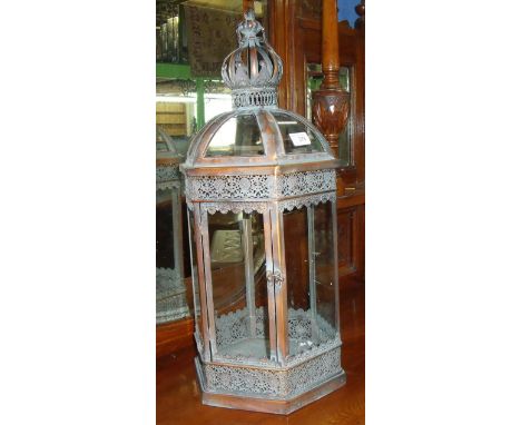 Large glazed lantern with swing handle and pierced fret work detail to the metalwork  