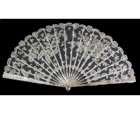 A Large Circa 1890's Honiton Lace Fan, mounted on silvered and gilded pink mother-of-pearl sticks. The machine net leaf is ap
