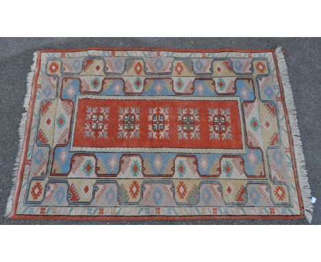 A vintage 20th century Anatolian Turkish carpet floor rug. The rug featuring burdock motifs surrounding the red central field