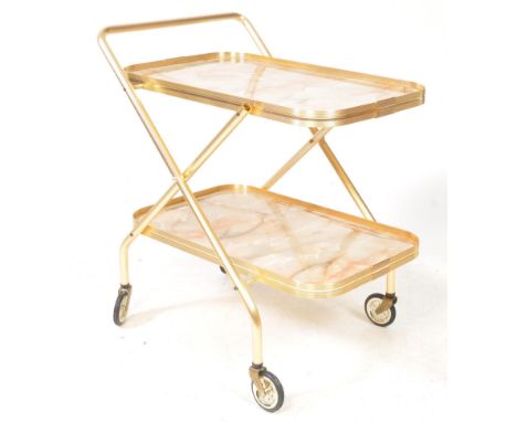 A vintage mid 20th century two tier gilt tea trolley. The trolley raised on castors, having gilt tone frame. With marble effe
