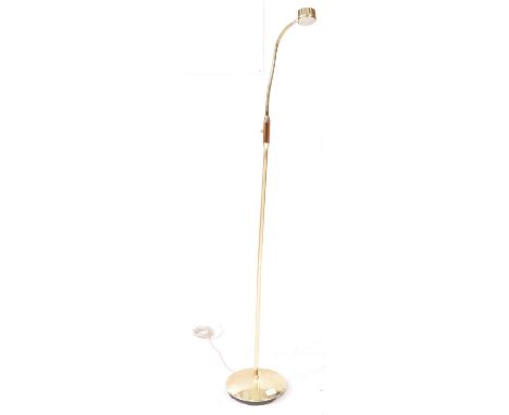 A contemporary gilt brass tone floor standing standard lamp. The lamp having a rounded base with gooseneck adjustable arm to 