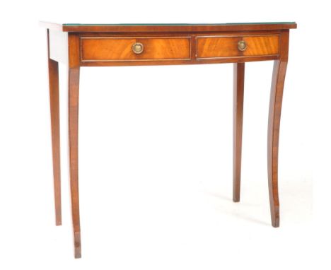 A George III revival mahogany writing table desk / console table. Featuring two drawers with brass, round handles. Raised on 