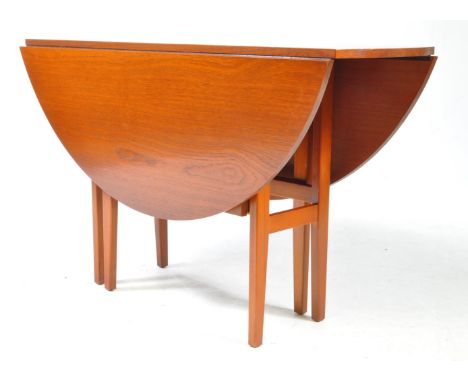 British Modern Design - A mid 20th century teak wood folding space saver gate leg dining table. The table raised on tapered l