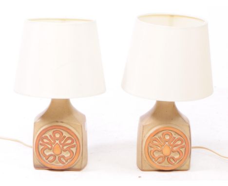 A pair of mid 20th century Cornish Ware table lamps. Each having a ceramic base, with abstract circulat desing to front.35x20