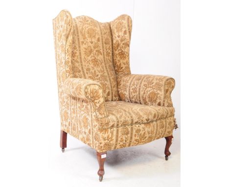 A 19th century late Victorian wingback armchair. The chair raised on cabriole legs to front, with tapestry upholstered seat a