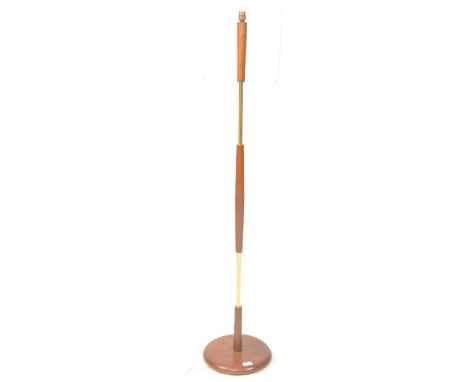 British Modern Design - A vintage mid 20th century teak and brass floor standing standard lamp. The lamp raised on a rounded 