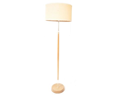 


Danish Modern Design - A mid 20th century teak and brass floor standing standard lamp. The lamp featuring a rounded base, 