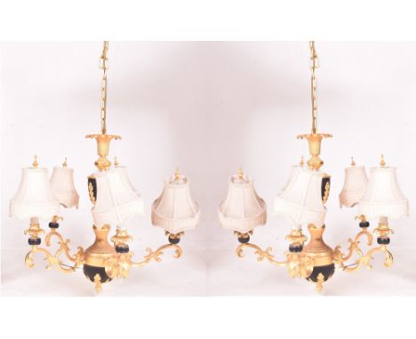 A pair of French Empire Louis XV inspired vintage gilt &amp; black painted five arm chandelier ceiling lights. Each having a 