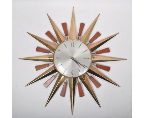 British Modern Design - Mid century retro sunburst wall hanging clock. Silver face with ebonised Arabic chapter ring with bra
