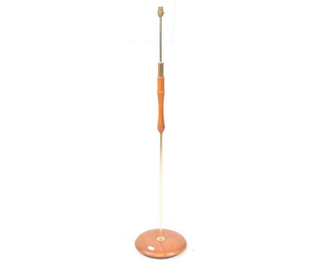 British Modern Design - A vintage mid 20th century teak and brass floor standing standard lamp. The lamp raised on a rounded 