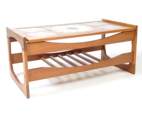 British Modern Design - A vintage mid 20th century tile topped teak coffee table. The table having a flower design tiled top,